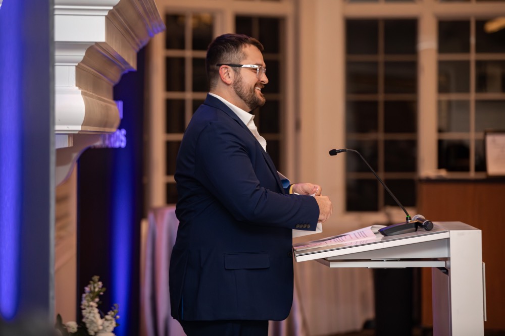 Alex Hogarth talking into microphone